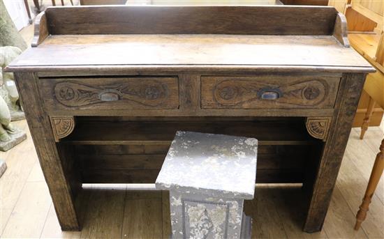 A carved oak hall table, carved and painted with a small ladybird, W.128cm